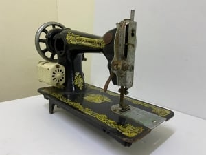 An old black sewing machine decorated with golden patterns - 5