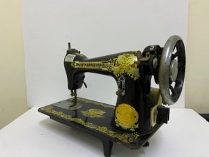 An old black sewing machine decorated with golden patterns - 2