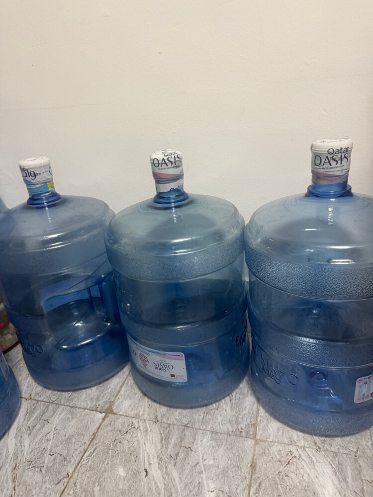 Empty Qatar Oasis water cans - 3