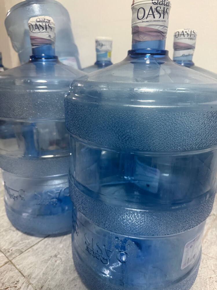 Empty Qatar Oasis water cans - 1