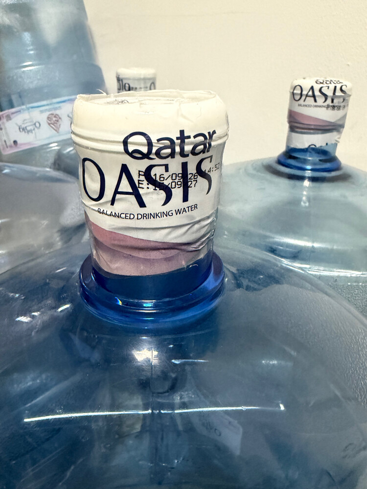 Empty Qatar Oasis water cans - 2