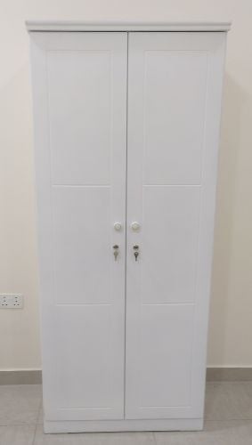Single bed and small cupboard.