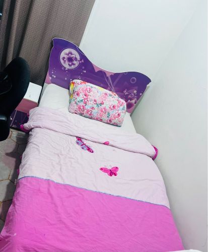 bed room with carpet and chair