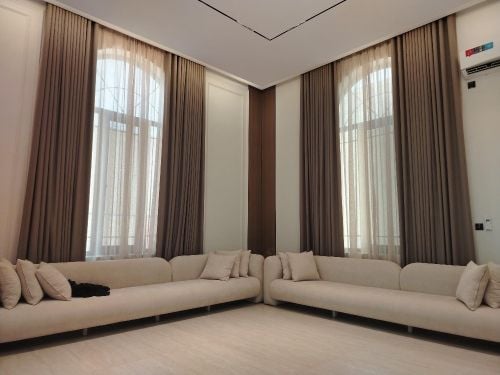 Sheer white curtains, gold tiebac
