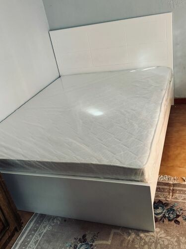 wooden bed with new mattress 