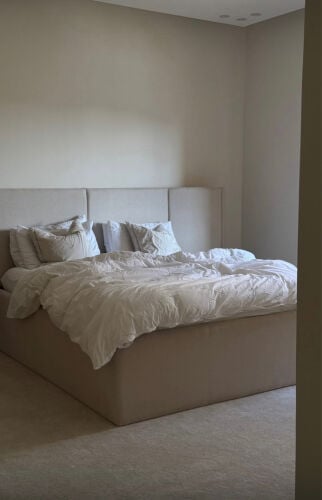 .A 160x200 beige bed in like-new condition.