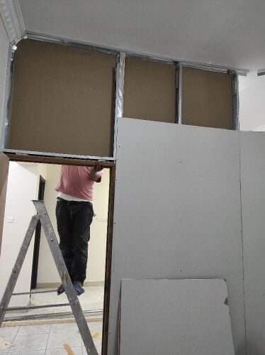 gypsum board partition work man