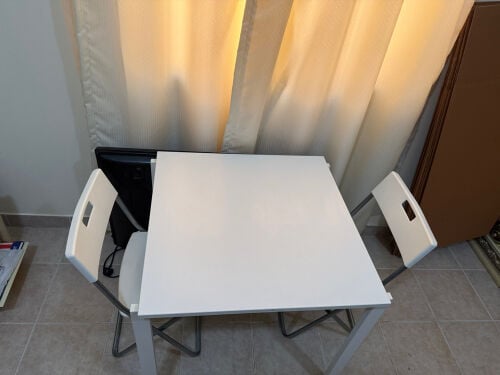 one white table and 2 chairs 
