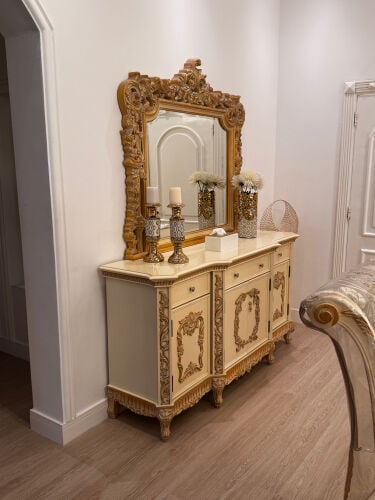 A dressing table with large mirrors