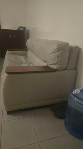 Leather sofa with wooden armrests