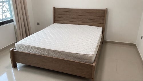 bed and mattress and side table