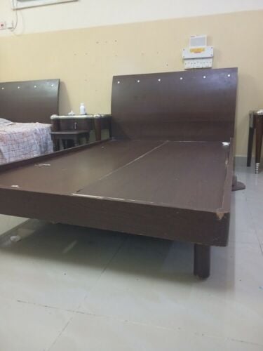dark brown single bed with mattress