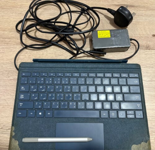 Microsoft keyboard, charger, and pe